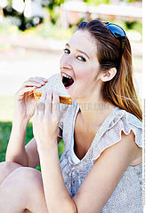 WOMAN EATING A SANDWICH