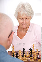 ELDERLY PEOPLE PLAYING CHESS