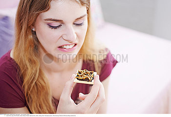 WOMAN EATING INSECT