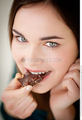 Woman eating chocolate.