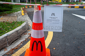 Singapur  Republik Singapur  Abgesperrte Zufahrt eines McDonalds Drive-Thru waehrend Covid-19