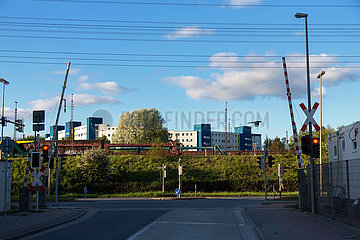 Deutschland  Bremen - Rote Ampeln am Bahnuebergang beim Industriehafen  hinten Wohnsiedlung
