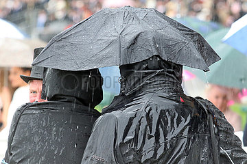Royal Ascot  two people under an umbrella at the racecourse