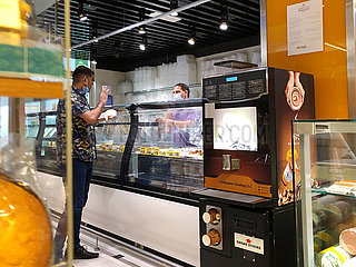 Dubai  UAE  September 2020- Customer and staff wearing masks in the supermarket.