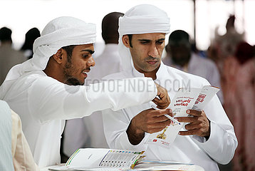 Dubai  local men betting at the racecourse