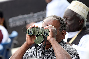 Dubai  local man at the racecourse looking through his binoculars