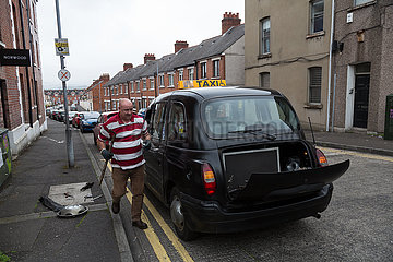 Grossbritannien  Nordirland  Belfast - Taxifahrer beim Reifenwechsel bei seinem Black Cab  ein klassisches Modell des Herstellers London Taxi Company