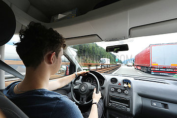 Kufstein  Oesterreich  junger Mann faehrt Auto auf der A12