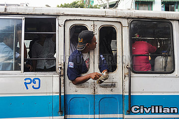 Yangon  Myanmar  Oeffentlicher Nahverkehr mit Pendlern und Busschaffner in einem vollbesetzten Bus
