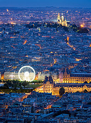 France  Paris  75001  75002  75009  75018. Aerial view of Paris rooftops at dusk  including The Louvre  and the Sacre Coeur basilica in Montmartre. Blue hour in the City of Light