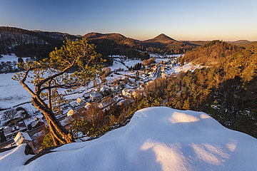 FRANCE  Alsace Bas-Rhin (67)  Northern Vosges Regional Nature Park  Wachtfels rock and Obersteinbach village in winter