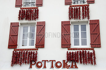 France. Pyrenees Atlantiques (64) Basque country. Espelette village. Facades covered with pepper strings