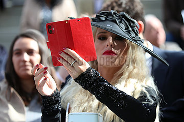 Paris  Frankreich  elegant gekleidete Frau mit Hut fotografiert mit ihrem Smartphone