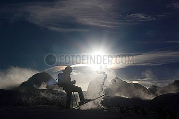 Obertraun  Oesterreich  Silhouette: Skifahrer steht bei Sonnenschein am Krippenstein