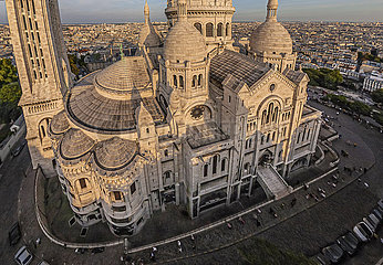France. Paris (75) Aerial view of the Sacre Coeur basilica  at the top of the Montmartre hill. Its construction was decided in 1870 (just after the Franco-German war)  and was completed in 1914. With nearly 11 million pilgrims and visitors per year  it is the second most visited religious monument in Paris after Notre-Dame
