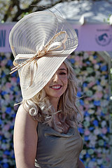 Aintree  Fashion on Ladies day: Young woman with hat at the racecourse