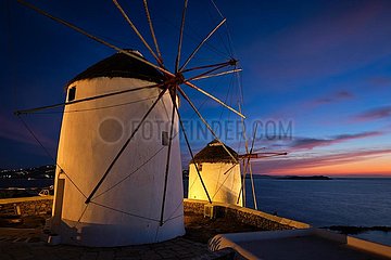 Traditional greek windmills on Mykonos island at sunrise  Cyclades  Greece