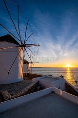 Traditional greek windmills on Mykonos island at sunrise  Cyclades  Greece