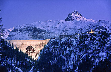 France. Savoie (73) Chevril-Tignes dam with the fresco of Hercules by Jean-Marie Pierret. and on the right  the church of Saint-Jacques des Boisses
