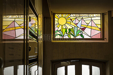 France. Paris (75) (9th district). At 32  Ballu street  stained glass window depicting 3 pyramids and two palm trees (above the front door)