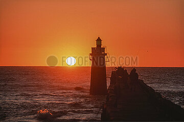 France. Aquitaine. Landes (40). Capbreton. Sunset on the pier and the lighthouse