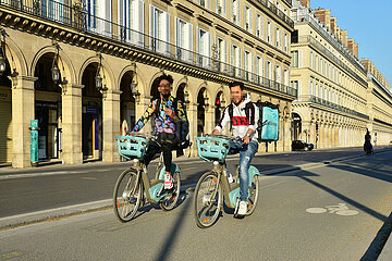France. Paris (1rst). Deliveroo on bicycle on rue de Rivoli without cars during the confinement of april 2020.