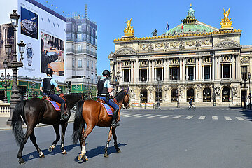 France. Paris (8th). Equestrian police patrol on the empty Opera square during the confinement of April 2020