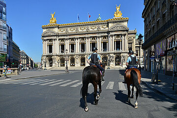 France. Paris (8th). Equestrian police patrol on the empty Opera square during the confinement of April 2020