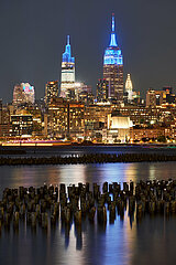 United States  New York City  Midtown. New York skyscrapers : Empire State Building and One Vanderbilt (leftside) and Chrysler Building (rightside) illuminated at night from across the Hudson River. Cityscape of West Village and Midtown Manhattan