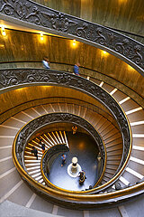 Italy. Lazio. Rome. Vatican Museums. The Bramante staircase is a famous monumental spiral staircase (allegorical double helicoidal)  which acts as an exit for the public. Reserved initially for riders  it was built in 1932 by the Italian architect Giuseppe Momo (pontificate of Pope Pius XI) and inspired by a nearby Renaissance staircase from the 16th century by the architect Bramante