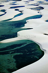 BRAZIL. NORDESTE. STATE OF MARANHAO. AERIAL VIEW OF LENCOIS MARANHENSES NATIONAL PARK. A UNIQUE PLACE IN THE WORLD: IMMACULATE WHITE SAND DUNES WAVING FOR TENS OF KILOMETERS  PUNCTUATED BY FRESHWATER LAKES. ONE OF THE MOST BEAUTIFUL NATIONAL PARKS IN THE COUNTRY