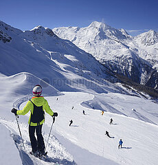 France . Alps. Savoy (73) Sainte Foy ski ressort  woman with helmet  on the back the Mont Pourri mountain