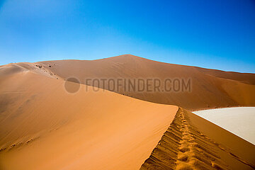 NAMIBIA. Namib-Naukluft National Park  walkers on Big Daddy red sand dune of Sossusvlei
