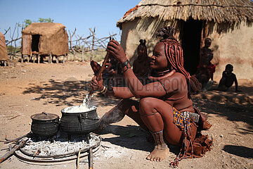 NAMIBIA  Kaokoland region  Opuwo  Himba preparing the meal