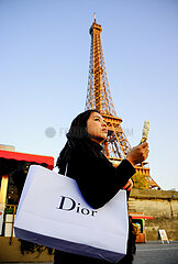 France. Paris (75) 7th arrondissement  Chinese tourist in front of the Eiffel Tower