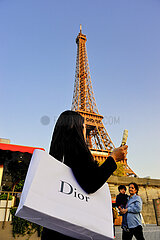 France. Paris (75) 7th arrondissement  Chinese tourist in front of the Eiffel Tower