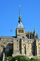 France. Manche (50). Mont Saint-Michel. View of the abbey and its bell tower with the statue of the Archangel Saint-Michel restored in 2016.