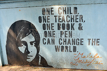 INDIA. MUMBAI ( BOMBAY) A QUOTE ON A SCHOOL WALL OF THE WOMEN RIGHT ACTIVIST MALALA YOUSAFZAI : ONE CHILD  ONE TEACHER  ONE BOOK & ONE PEN CAN CHANGE THE WORLD