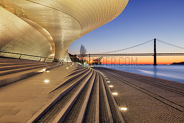 Portugal  Lisbon  The MMAT and the 25th of April Bridge over the Tagus River at sunrise. The Museum of Art  Architecture and Technology is the city's new cultural project specializing in art  architecture and technology