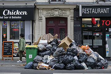 France. Paris (75) (14th district). At the beginning of March 2023  trash cans and rubbish pile up on the sidewalks  following a garbage collectors' strike  in protest against the government's pension reform project (here  Sante street  trash is piling up on the sidewalk  between two restaurants)