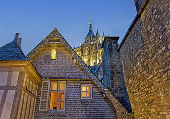 France. Normandy. Manche (50) Mont Saint Michel - The village: houses (inhabited all year round) along the southern walkway. In the background  the abbey houses and the bell tower of the church
