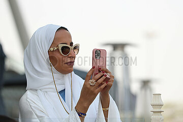 Doha  Katar  Frau macht ein Foto mit ihrem Smartphone