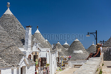 ITALY  PUGLIA  TRULLIS OF THE VILLAGE OF ALBEROBELLO  LISTED AS WORLD HERITAGE BY UNESCO. TRULLI ARE DRY-STONE DWELLINGS. THESE ARE REMARKABLE EXAMPLES OF MORTARLESS CONSTRUCTION  A TECHNIQUE INHERITED FROM PREHISTORY AND STILL USED IN THE REGION. THE DWELLINGS WITH THEIR PYRAMIDAL  DOME OR CONICAL ROOFS ARE CONSTRUCTED WITH LIME STONE PEBBLES COLLECTED IN THE NEIGHBORING FIELDS