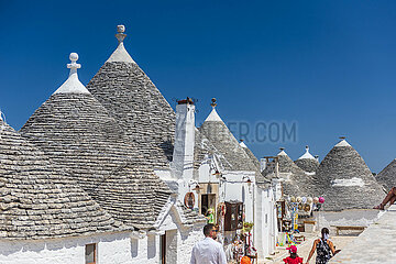 ITALY  PUGLIA  TRULLIS OF THE VILLAGE OF ALBEROBELLO  LISTED AS WORLD HERITAGE BY UNESCO. TRULLI ARE DRY-STONE DWELLINGS. THESE ARE REMARKABLE EXAMPLES OF MORTARLESS CONSTRUCTION  A TECHNIQUE INHERITED FROM PREHISTORY AND STILL USED IN THE REGION. THE DWELLINGS WITH THEIR PYRAMIDAL  DOME OR CONICAL ROOFS ARE CONSTRUCTED WITH LIME STONE PEBBLES COLLECTED IN THE NEIGHBORING FIELDS