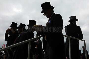 Royal Ascot  Fashion: Men with top hats silhouetted against the sky