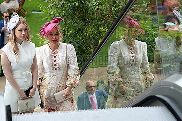 Royal Ascot  Fashion: Women with hats on an escalator inside the grandstand