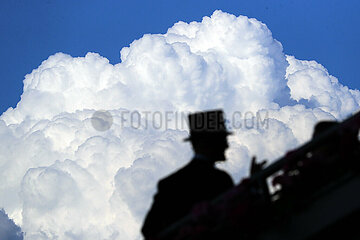 Royal Ascot  Silhouette of a man with top hat in front of a big cloud
