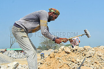 Workers Dedicate Themselves to Breaking Rocks In Stone State