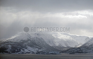 Evenes  Norwegen  Berglandschaft an der Kueste im Winter bei Regenwetter
