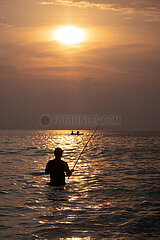 Senggigi  Indonesien  Silhouette: Mann angelt bei Sonnenuntergang im Meer